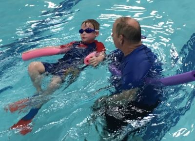 Swimmer in pool with instructor