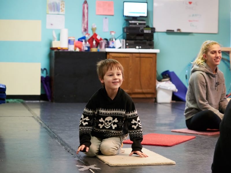 boy sitting on mat