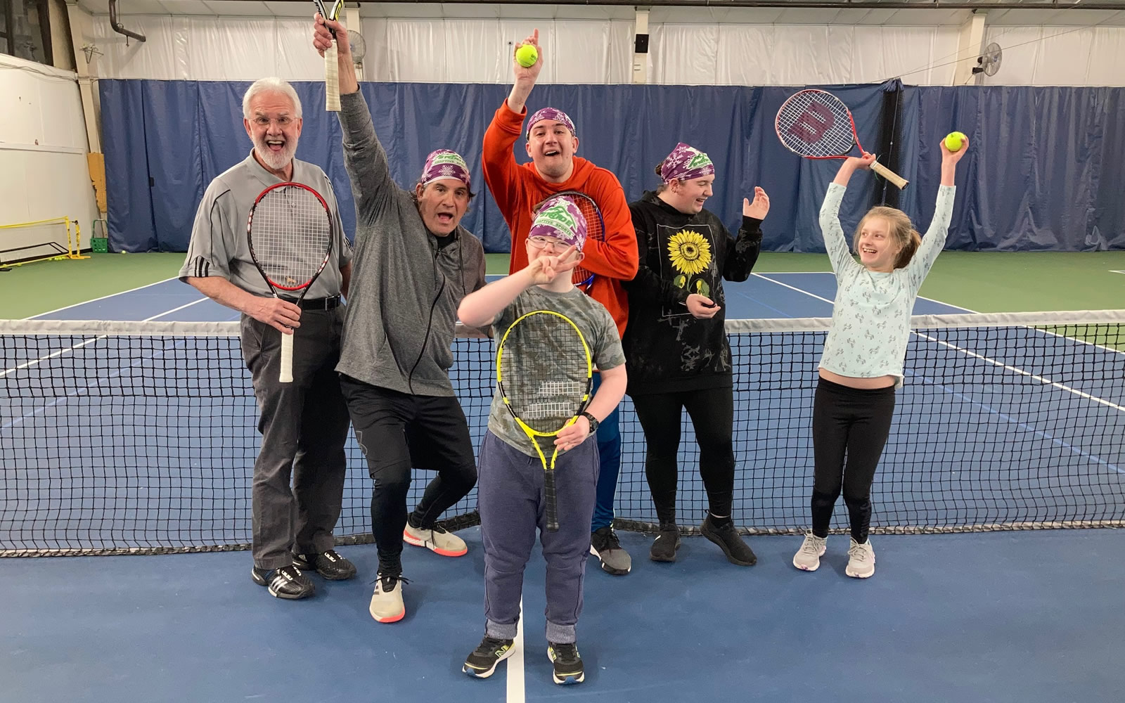 Happy group of tennis students