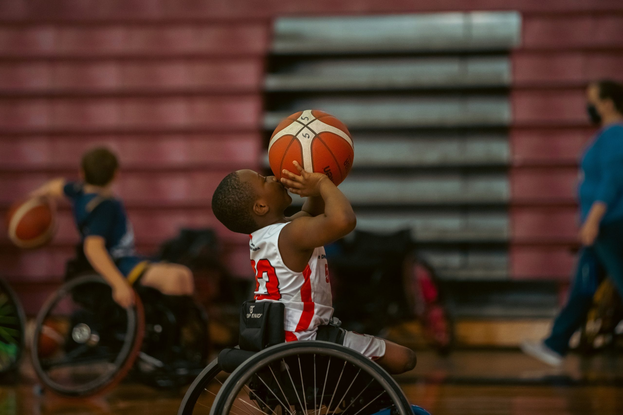Young boy playing wheelchair basketball